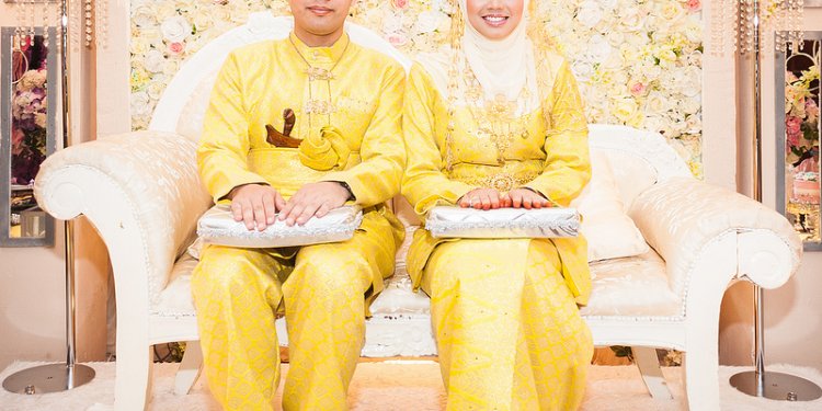 Malay Groom Bride wearing yellow coloured traditional songket dress
