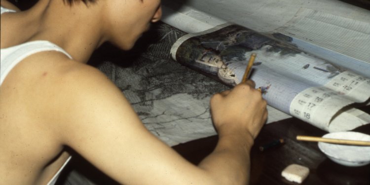 Worker translating image onto drafting paper, silk jacquard factory near Hangzchou