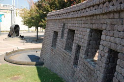 John Wesley Dobbs Plaza Atlanta, Georgia. The wall at right recalls ancient fortifications in southern Africa. In the background is a sculpture of Dobbs who encouraged African Americans to register to vote.