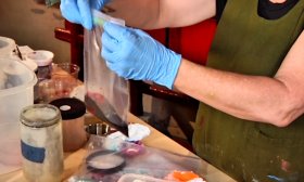 Woman in Blue Gloves with Cloth Dyeing Materials