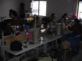 Women Working at Table in a Hat Factory